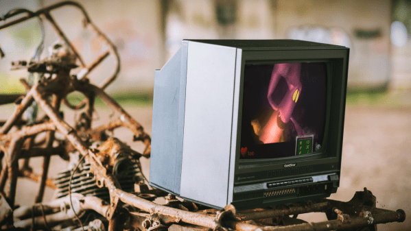 Old CRT Television playing Luigi's Mansion on a rusted out bike (Original Photo by Anete Lusina)